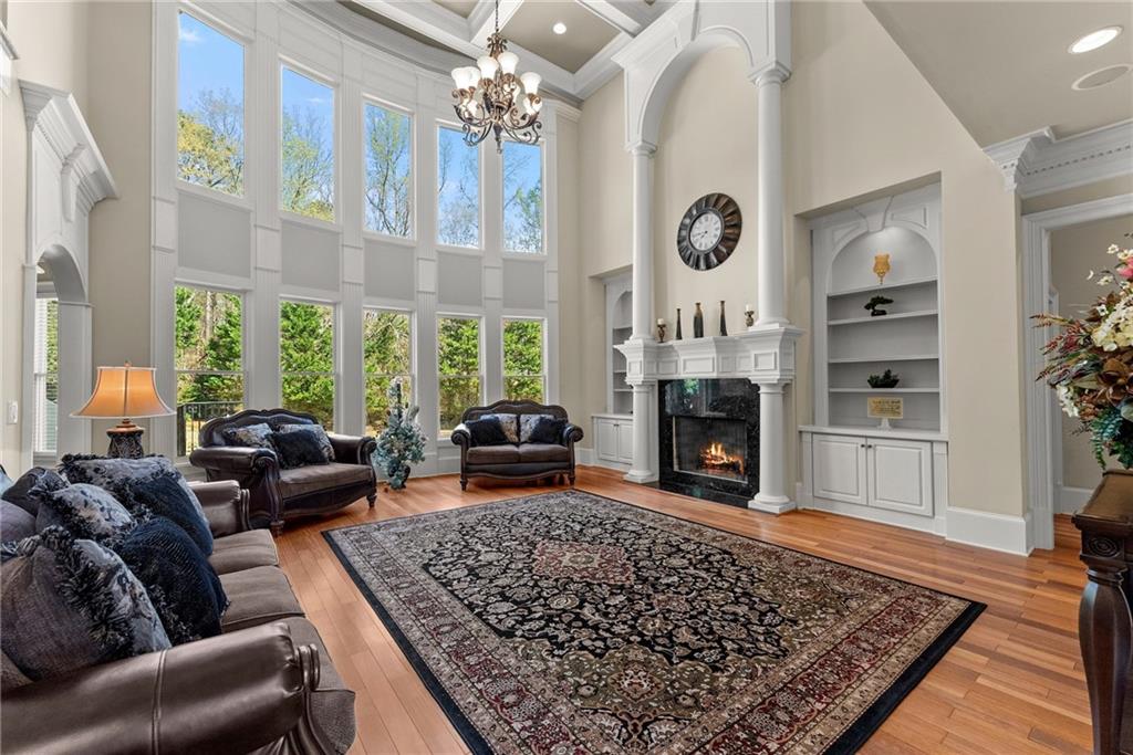 1310 Settles Road Suwanee, GA 30024 - Photo 7 of 71 a living room with furniture a fireplace a rug and a large window