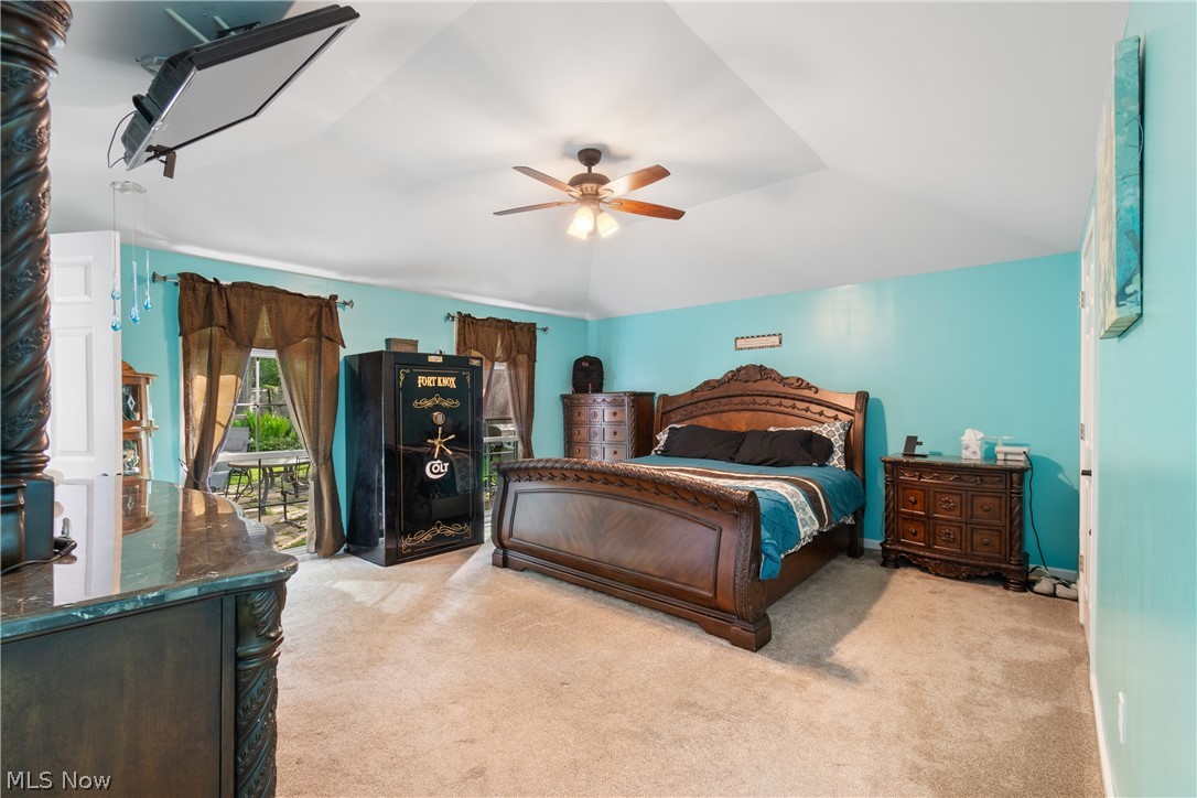 3255 Old Weymouth Road Medina, OH 44256 - Photo 15 of 31 Carpeted bedroom featuring vaulted ceiling, ceiling fan, and access to exterior