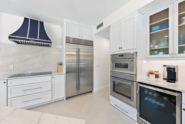 a kitchen with cabinets and stainless steel appliances