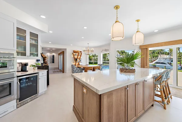 a kitchen with stainless steel appliances granite countertop a sink a stove and a refrigerator