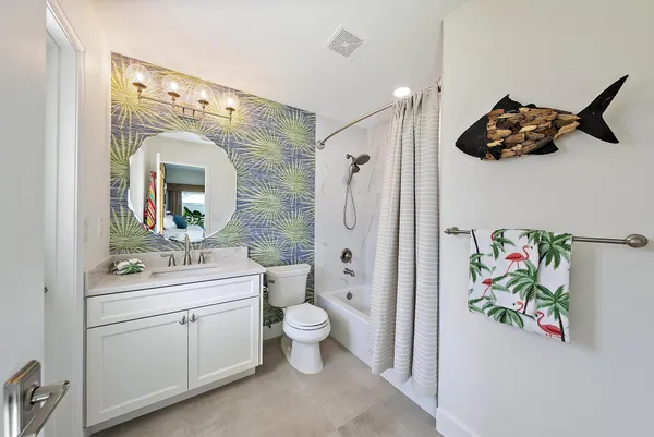 a spacious bathroom with a toilet sink and mirror