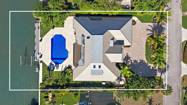 a front view of a house with a garden and trees