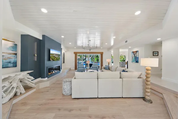 a living room with furniture and a chandelier