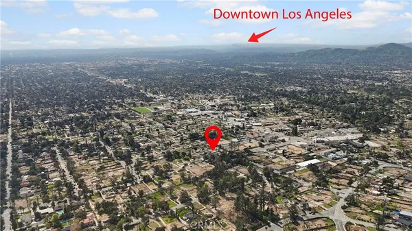an aerial view of houses covered in trees