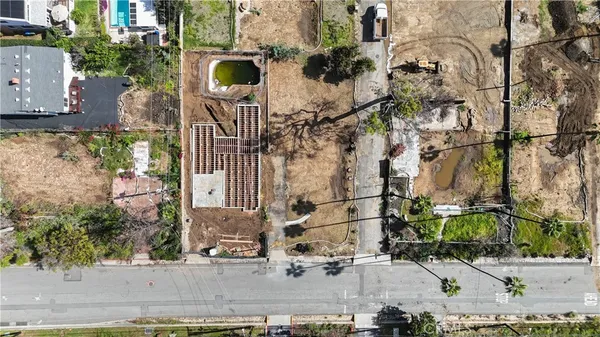 an aerial view of residential houses with outdoor space