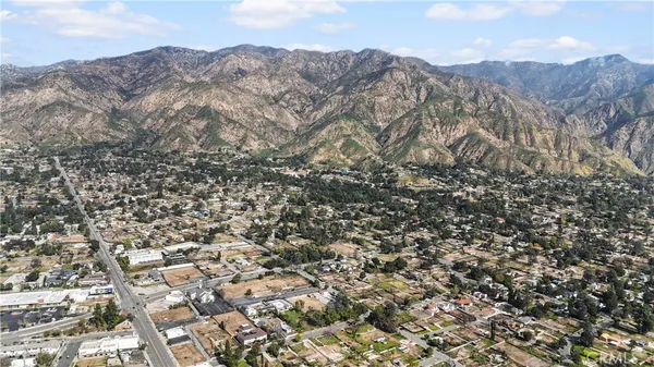 an aerial view of residential building and trees around