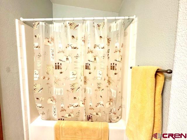 802 Bluffs Boulevard Cortez, CO 81321 - Photo 19 of 30 a bathroom with a shower curtain