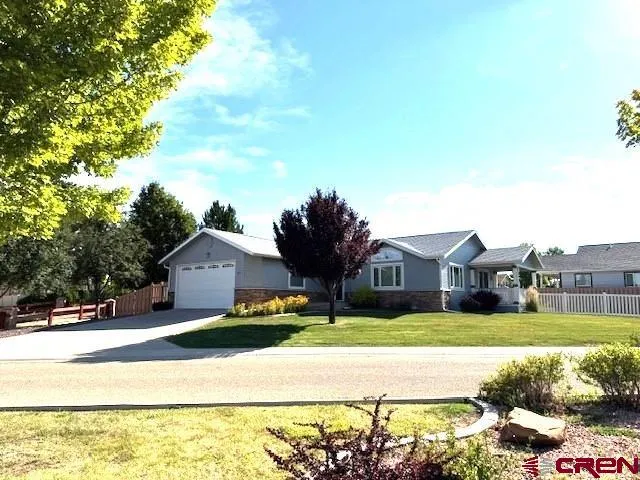 a front view of a house with a garden and yard