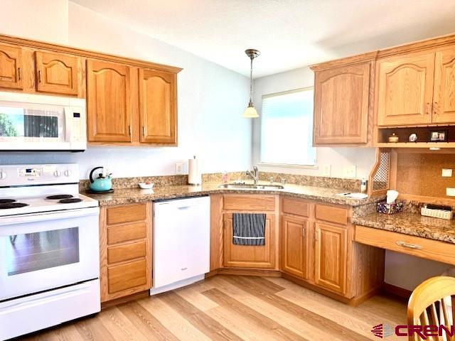 802 Bluffs Boulevard Cortez, CO 81321 - Photo 9 of 30 a kitchen with stainless steel appliances granite countertop a stove a sink and a microwave