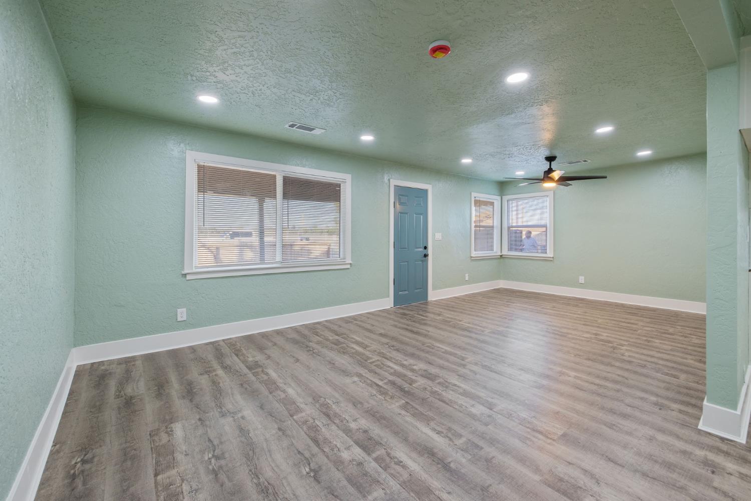 4722 East Florence Avenue Fresno, CA 93725 - Photo 11 of 51 an empty room with wooden floor and windows