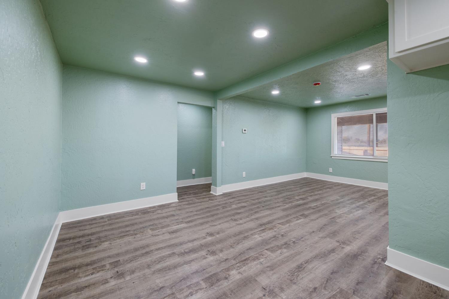 4722 East Florence Avenue Fresno, CA 93725 - Photo 16 of 51 an empty room with wooden floor and windows