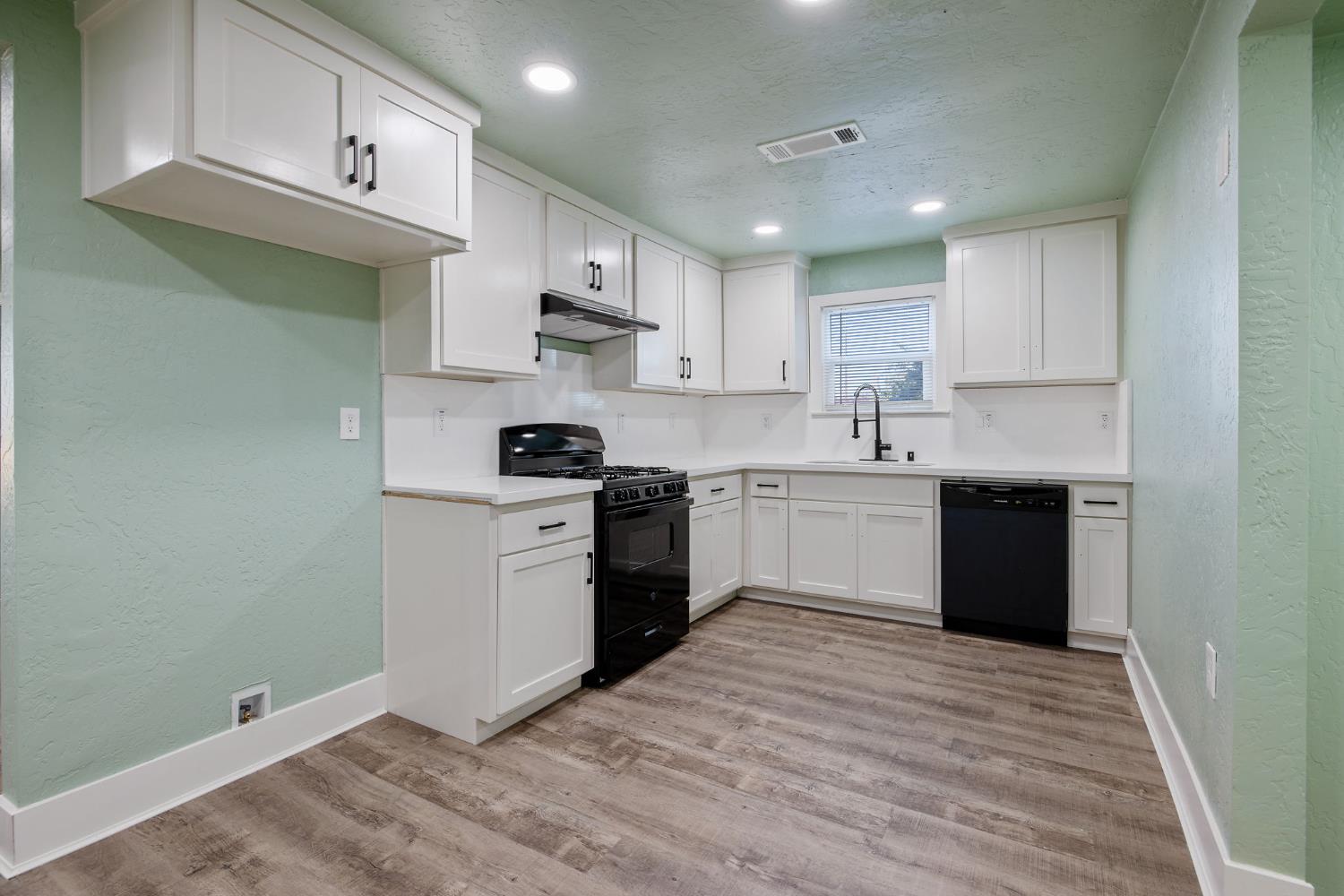 4722 East Florence Avenue Fresno, CA 93725 - Photo 18 of 51 a kitchen with stainless steel appliances granite countertop a sink and cabinets