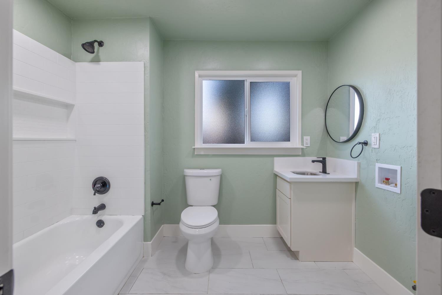 4722 East Florence Avenue Fresno, CA 93725 - Photo 23 of 51 a bathroom with a toilet sink vanity tub and shower