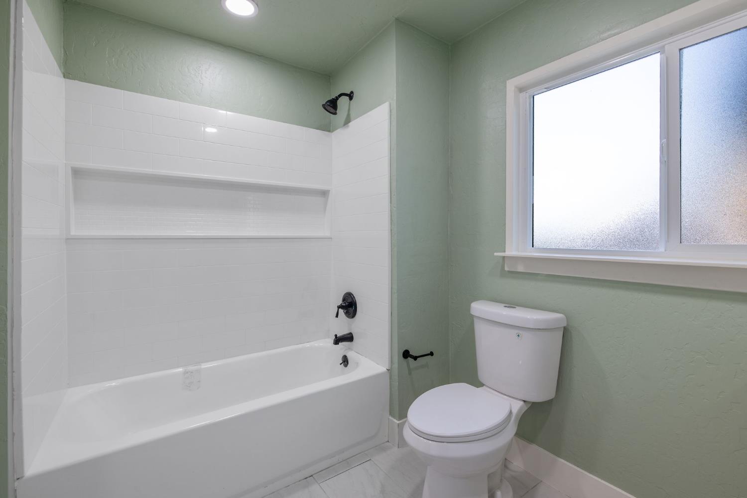 4722 East Florence Avenue Fresno, CA 93725 - Photo 24 of 51 a bathroom with a toilet a sink and a bathtub