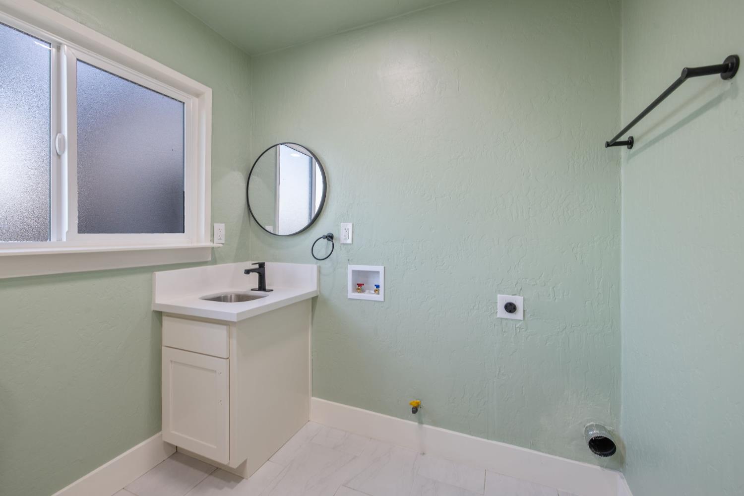 4722 East Florence Avenue Fresno, CA 93725 - Photo 25 of 51 a bathroom with a sink and a mirror