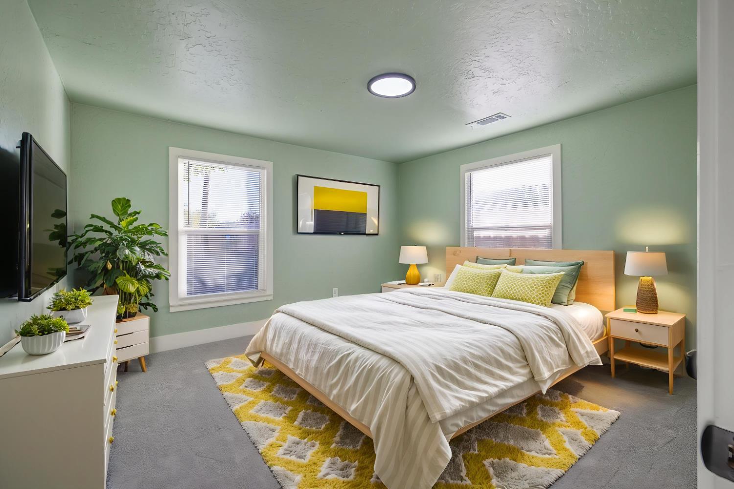 4722 East Florence Avenue Fresno, CA 93725 - Photo 28 of 51 a bedroom with a bed and a potted plant