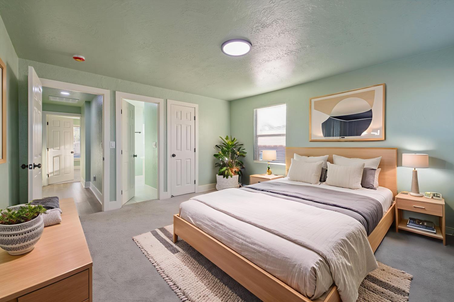 4722 East Florence Avenue Fresno, CA 93725 - Photo 32 of 51 a spacious bedroom with a bed and a potted plant