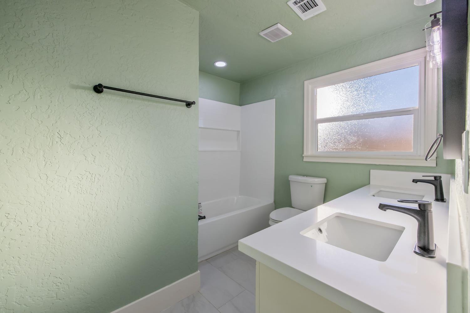 4722 East Florence Avenue Fresno, CA 93725 - Photo 34 of 51 a bathroom with a sink and a vanity