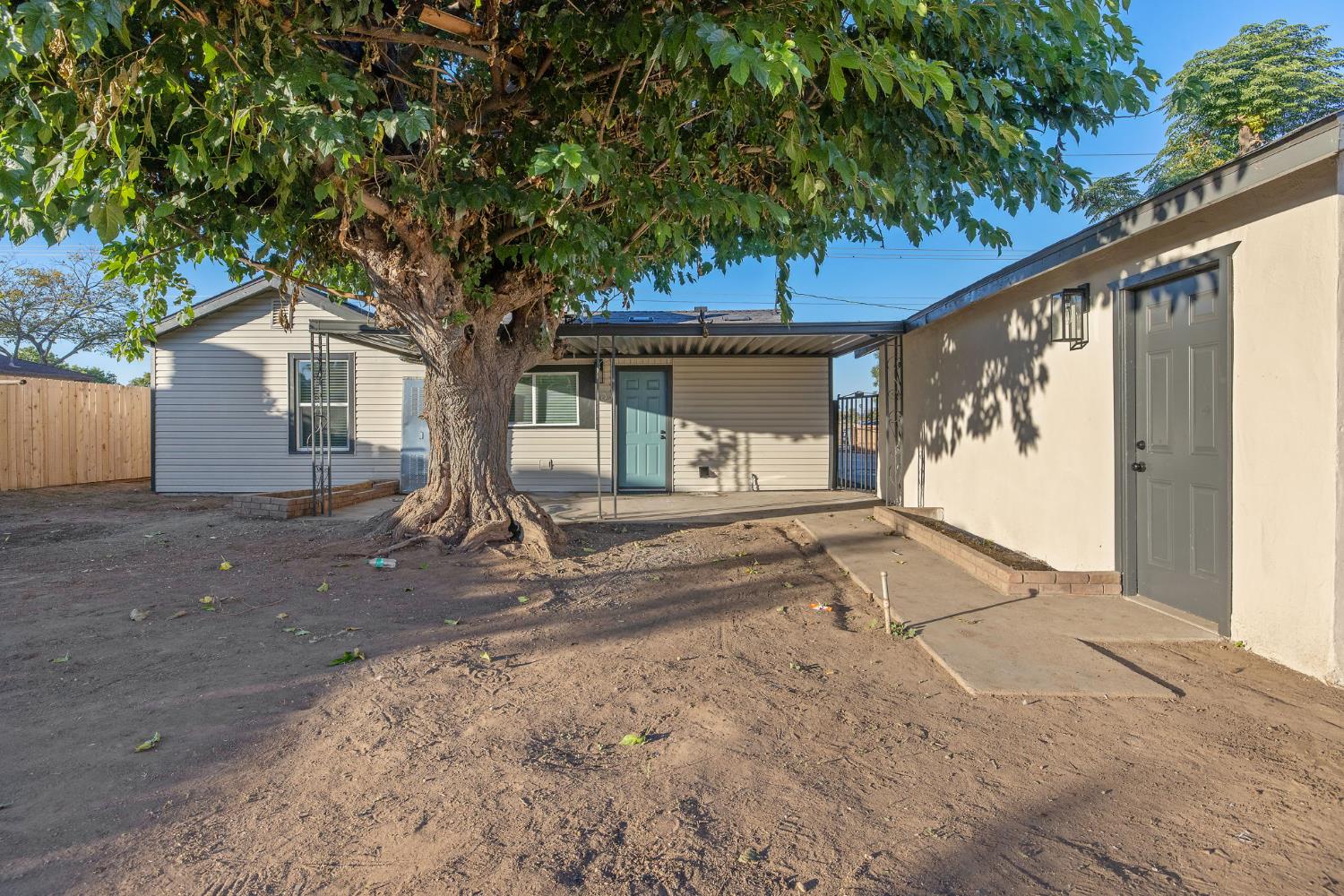 4722 East Florence Avenue Fresno, CA 93725 - Photo 44 of 51 a front view of a house with a tree