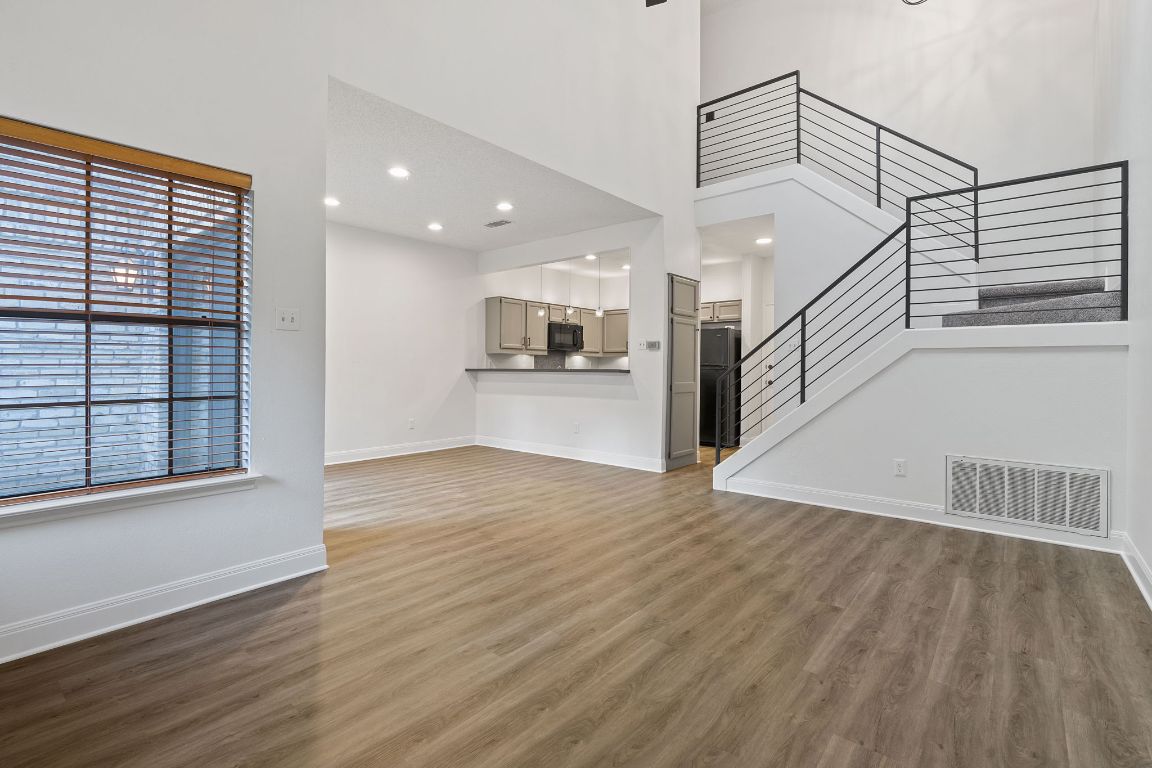 10819 Crown Colony Drive, Unit 22 Austin, TX 78747 - Photo 4 of 16 a view of a kitchen with wooden floor and electronic appliances