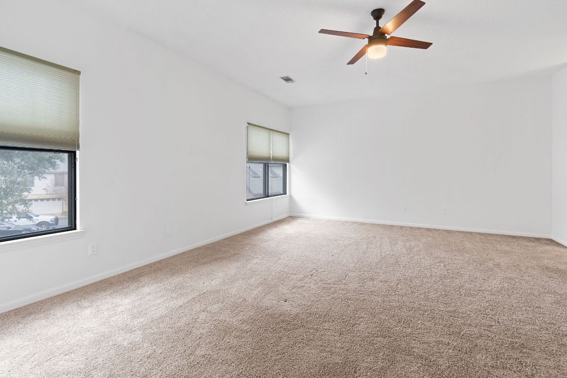 10819 Crown Colony Drive, Unit 22 Austin, TX 78747 - Photo 10 of 16 a view of a big room with closet and windows