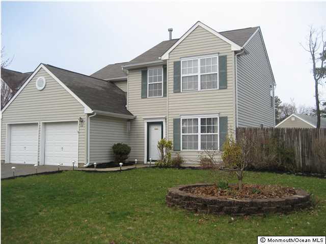 129 Starboard Road Brick, NJ 08723 - Photo 1 of 3 a front view of a house with a yard