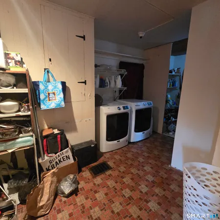 a view of kitchen and living room with wooden floor