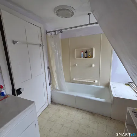 a bathroom with a tub and a sink