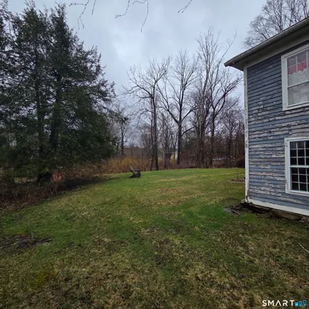 a view of a backyard with large trees