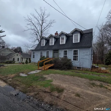a view of a brick house with a yard