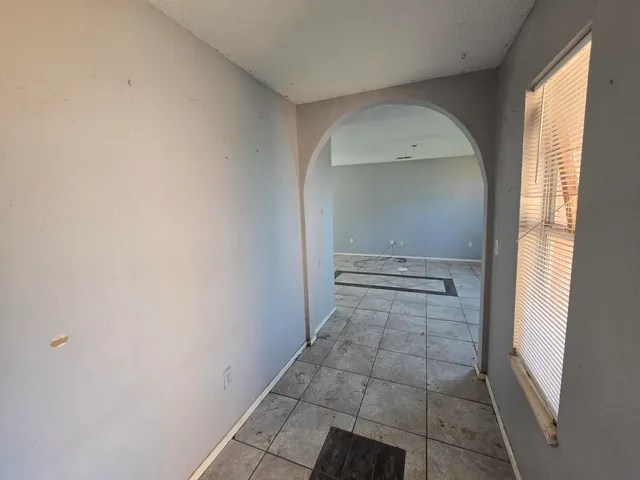 a view of empty room with window and front door