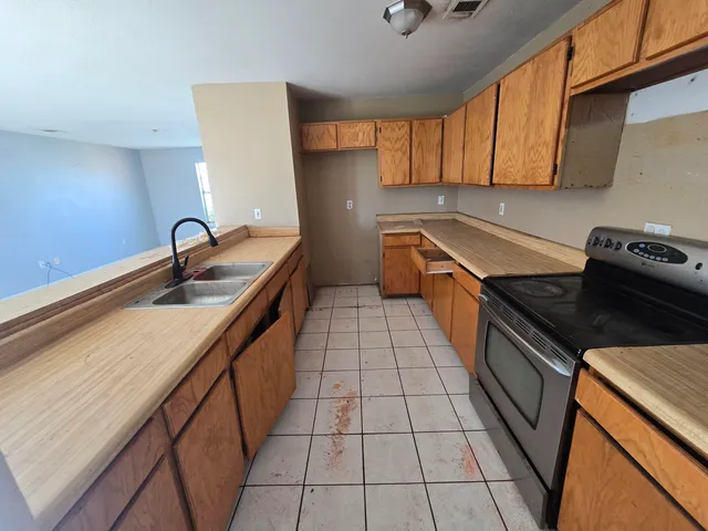 a kitchen with a sink and cabinets