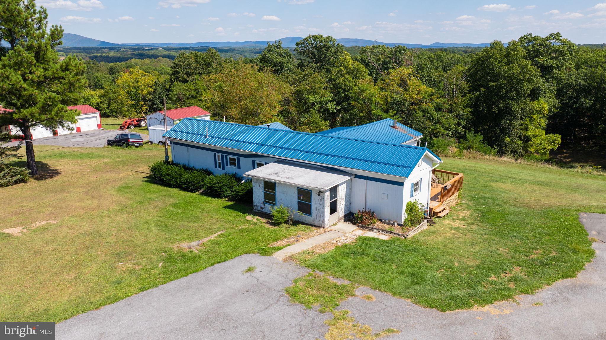 5386 Pious Ridge Road Berkeley Springs, WV 25411 - Photo 15 of 20 a view of a big house with a big yard and potted plants
