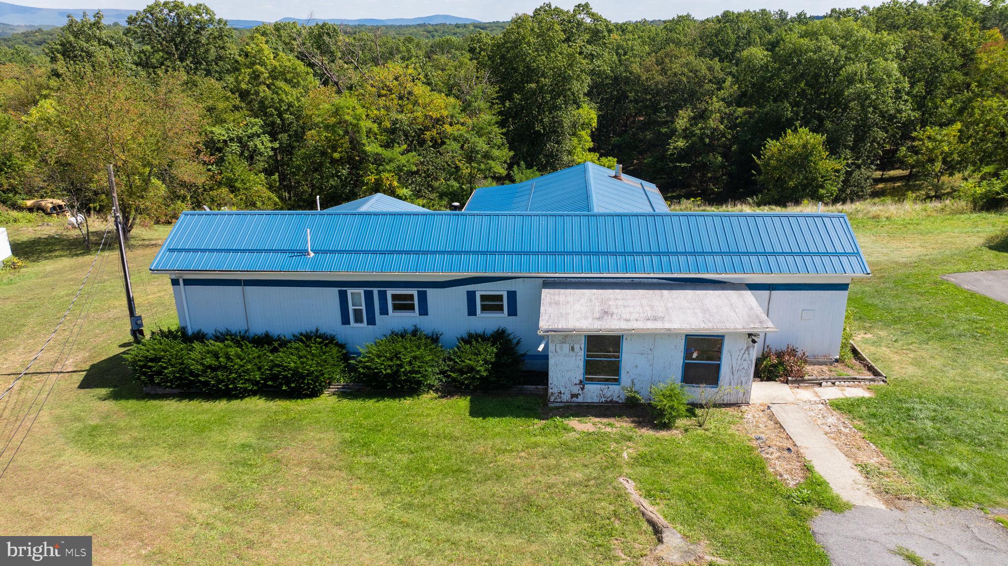 5386 Pious Ridge Road Berkeley Springs, WV 25411 - Photo 2 of 20 a view of a house with garden