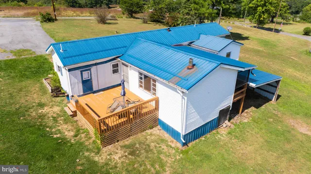 an aerial view of a house with pool ocean view and mountain view