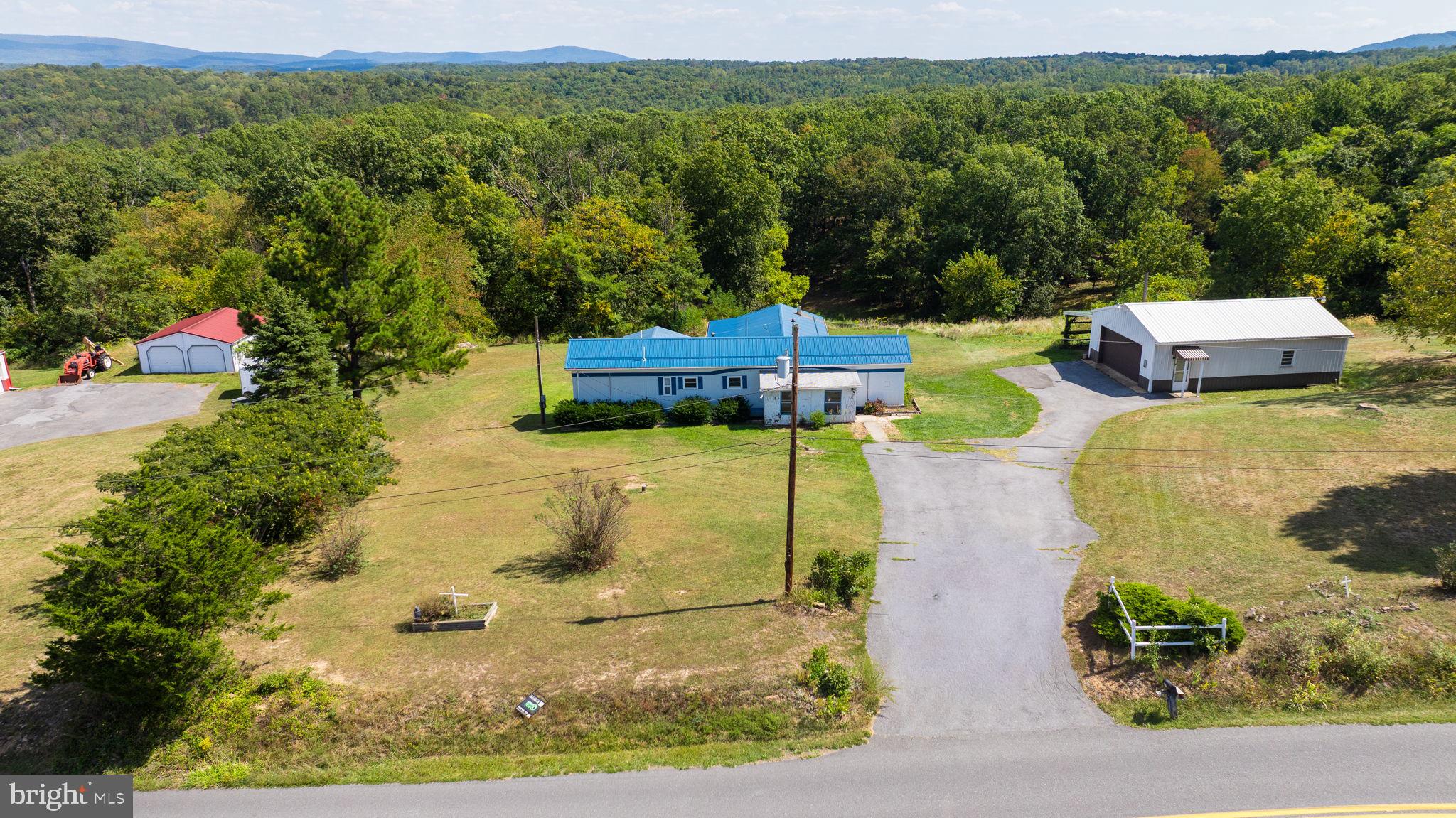 5386 Pious Ridge Road Berkeley Springs, WV 25411 - Photo 6 of 20 a view of a swimming pool with a yard