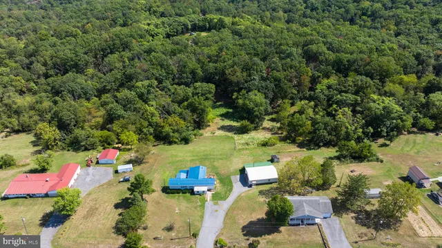 an aerial view of a house with a yard basket ball court and outdoor seating