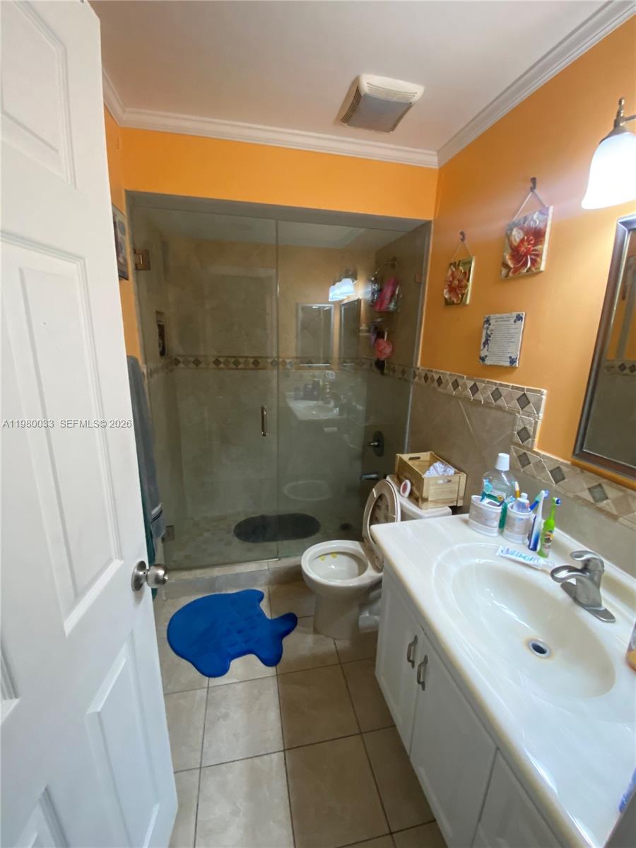 13815 Southwest 54th Street Miami, FL 33175 - Photo 14 of 23 a bathroom with a double vanity sink toilet and shower