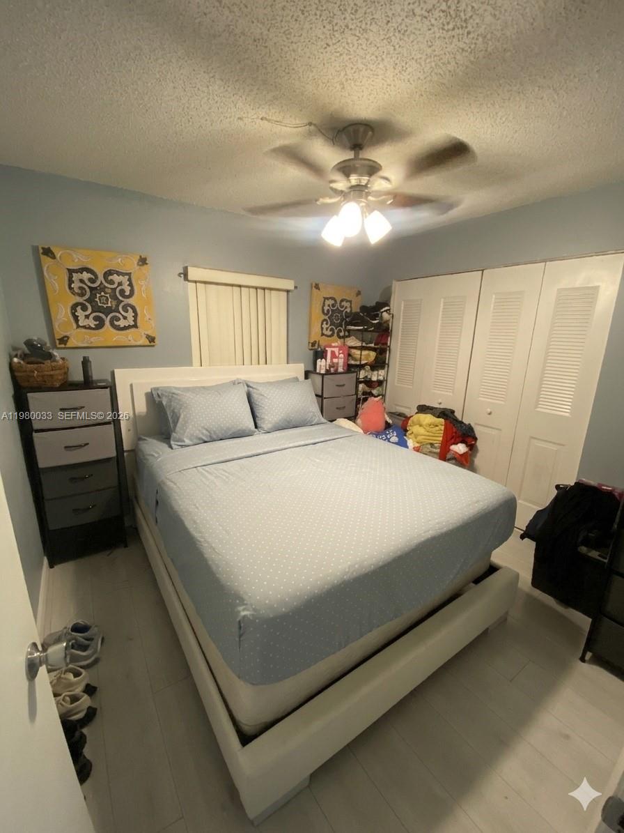 13815 Southwest 54th Street Miami, FL 33175 - Photo 15 of 23 a bedroom with a bed and a chandelier