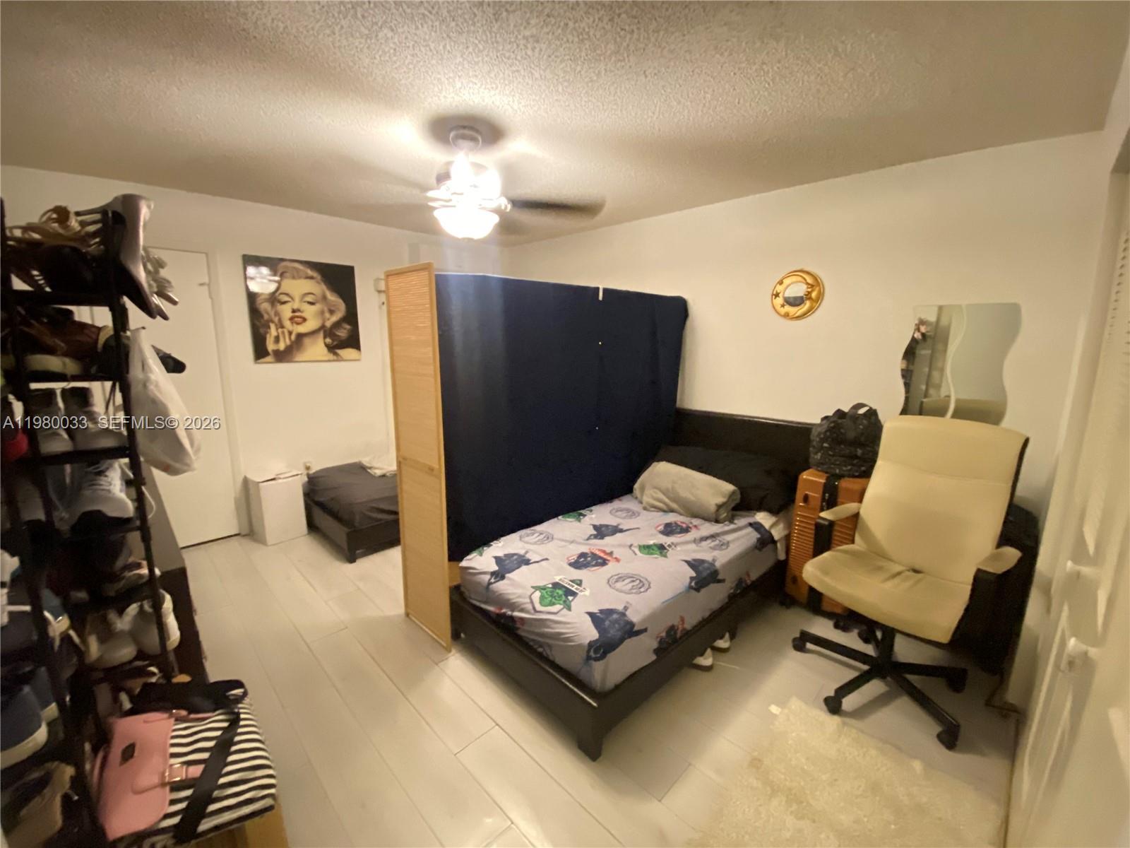 13815 Southwest 54th Street Miami, FL 33175 - Photo 16 of 23 a bedroom with a bed and wooden floor