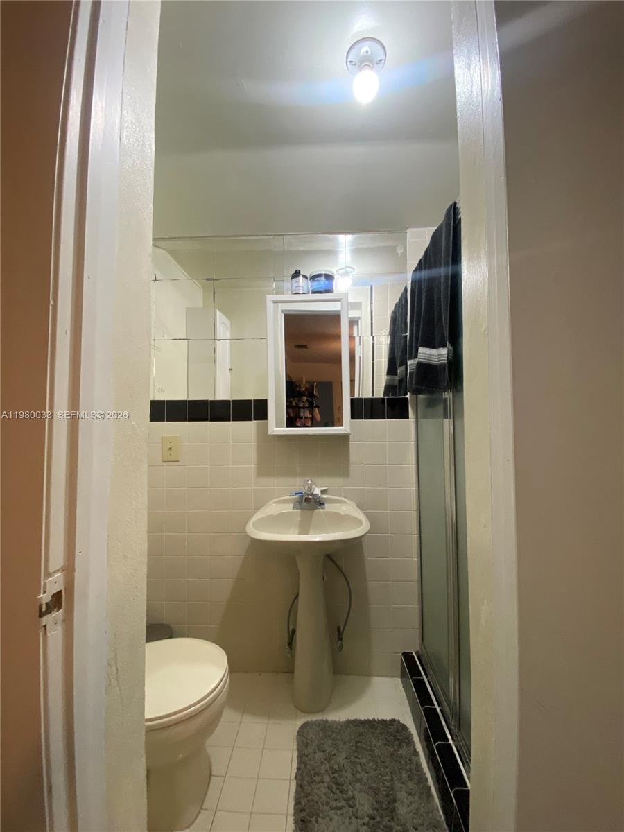 13815 Southwest 54th Street Miami, FL 33175 - Photo 18 of 23 a bathroom with a sink toilet and shower