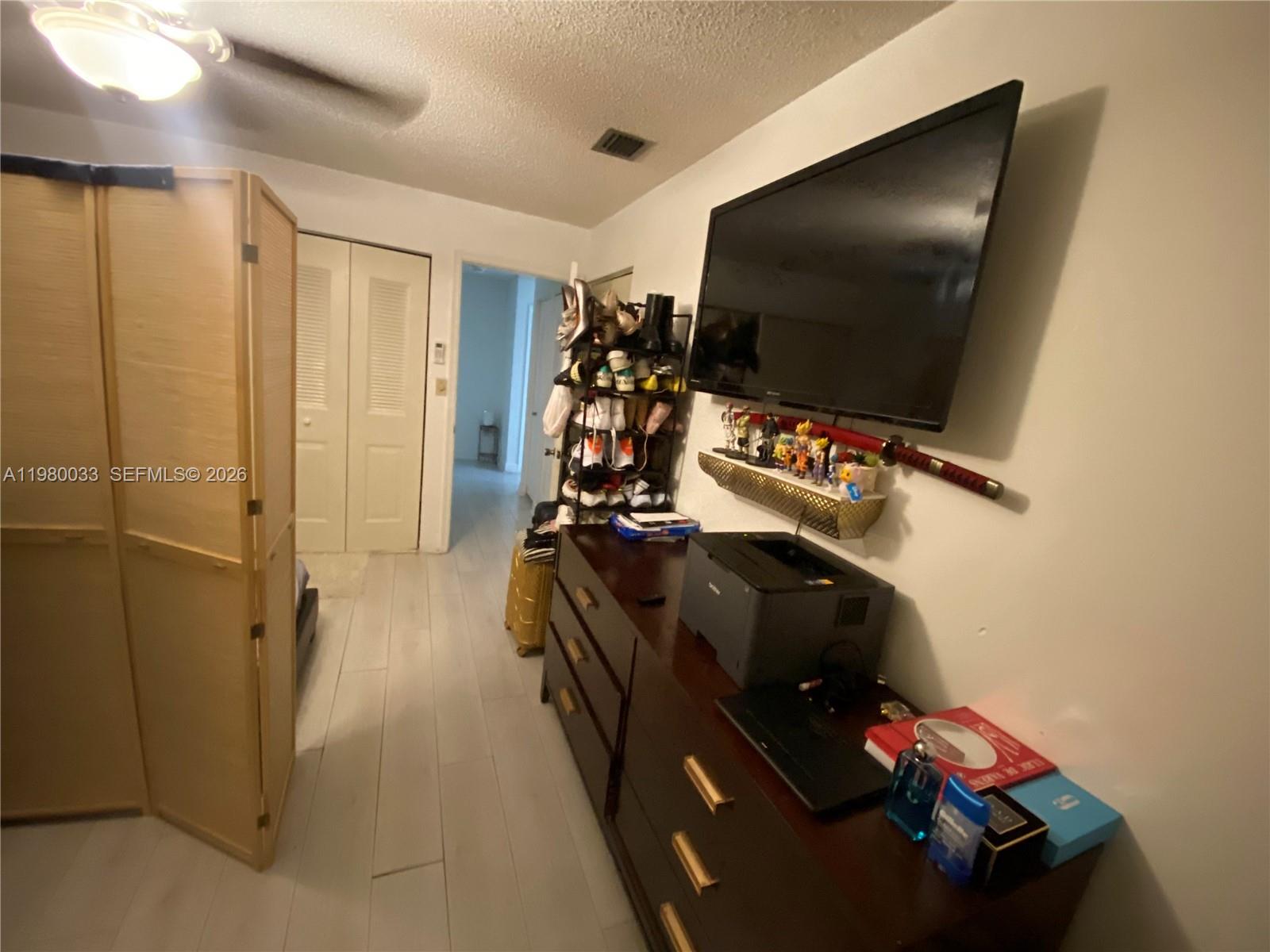 13815 Southwest 54th Street Miami, FL 33175 - Photo 20 of 23 a living room with furniture and a flat screen tv