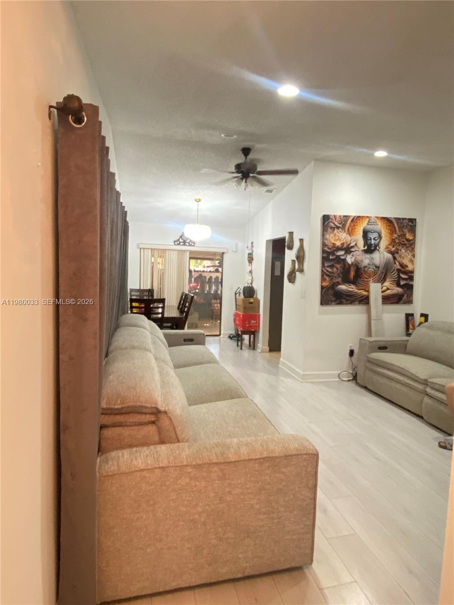 13815 Southwest 54th Street Miami, FL 33175 - Photo 2 of 23 a living room with furniture and a flat screen tv