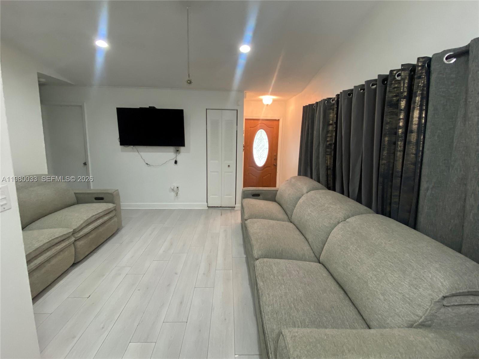 13815 Southwest 54th Street Miami, FL 33175 - Photo 5 of 23 a living room with furniture and a flat screen tv