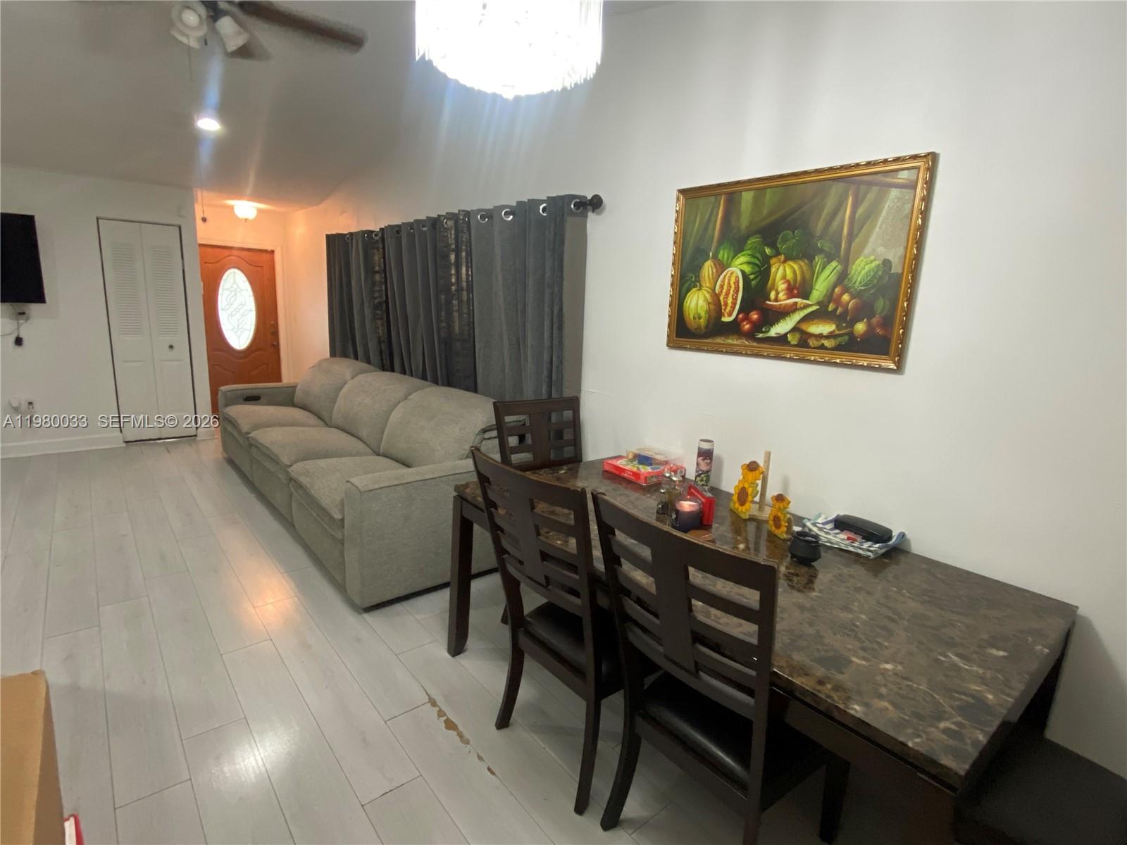 13815 Southwest 54th Street Miami, FL 33175 - Photo 6 of 23 a living room with furniture and a wooden floor