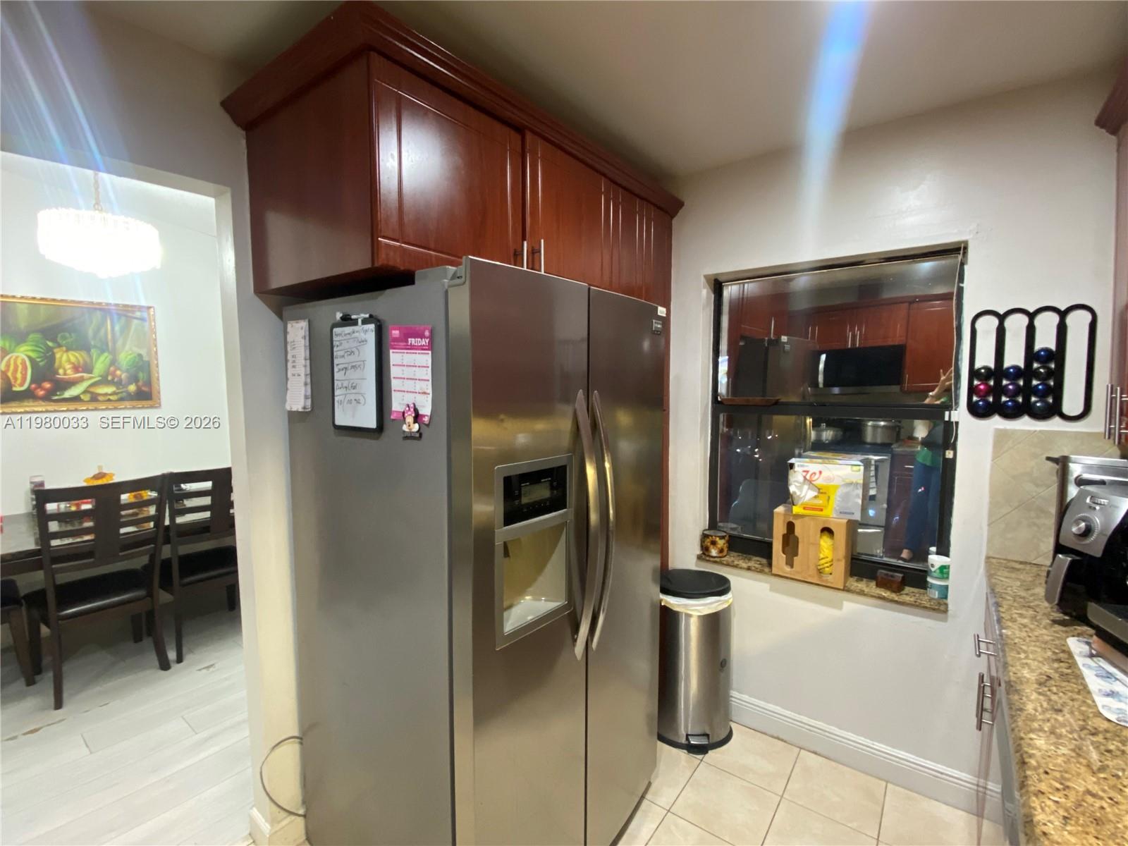 13815 Southwest 54th Street Miami, FL 33175 - Photo 9 of 23 a kitchen with stainless steel appliances kitchen island granite countertop a refrigerator and a stove