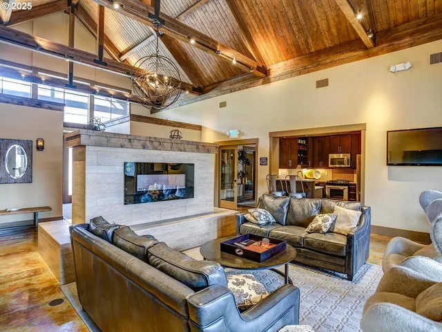 a kitchen with stainless steel appliances granite countertop a sink a stove a refrigerator cabinets and chairs