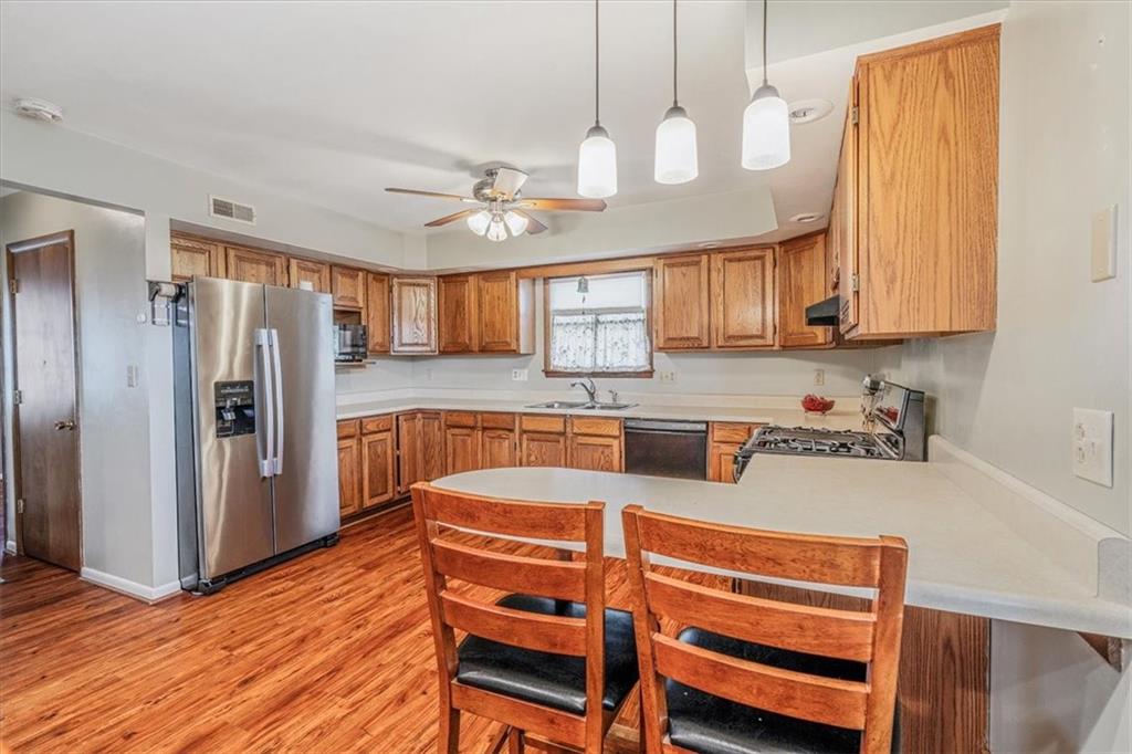 206 Washington Street Beaver, PA 15009 - Photo 16 of 32 a kitchen with stainless steel appliances granite countertop a refrigerator a stove and a sink with cabinets