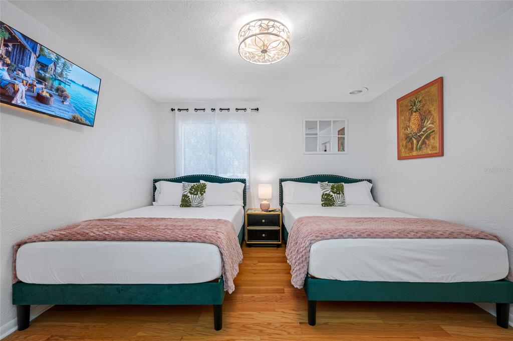 2153 Karan Way Clearwater, FL 33763 - Photo 27 of 65 a bedroom with two beds and painting on the wall
