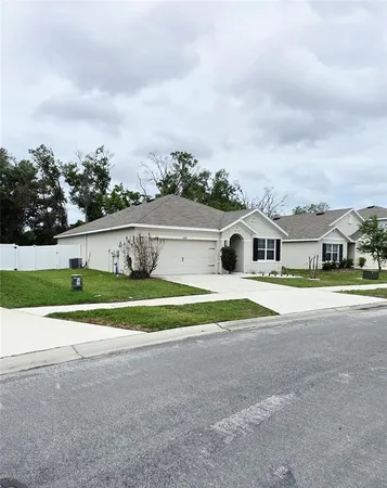 a view of house with outdoor space and street